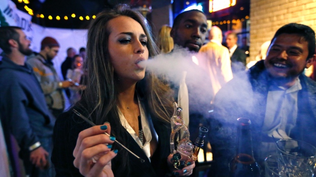 Partygoers celebrate in Colorado, where pot became legal in 2012, in this 2013 file photo. As Canada moves toward legalization, etiquette questions about using marijuana at parties and in other social settings will need to be addressed.   